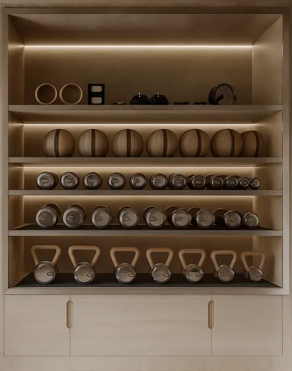 Bespoke gym storage and curated fitness equipment within an elegant wellness project designed by LUV Studio.